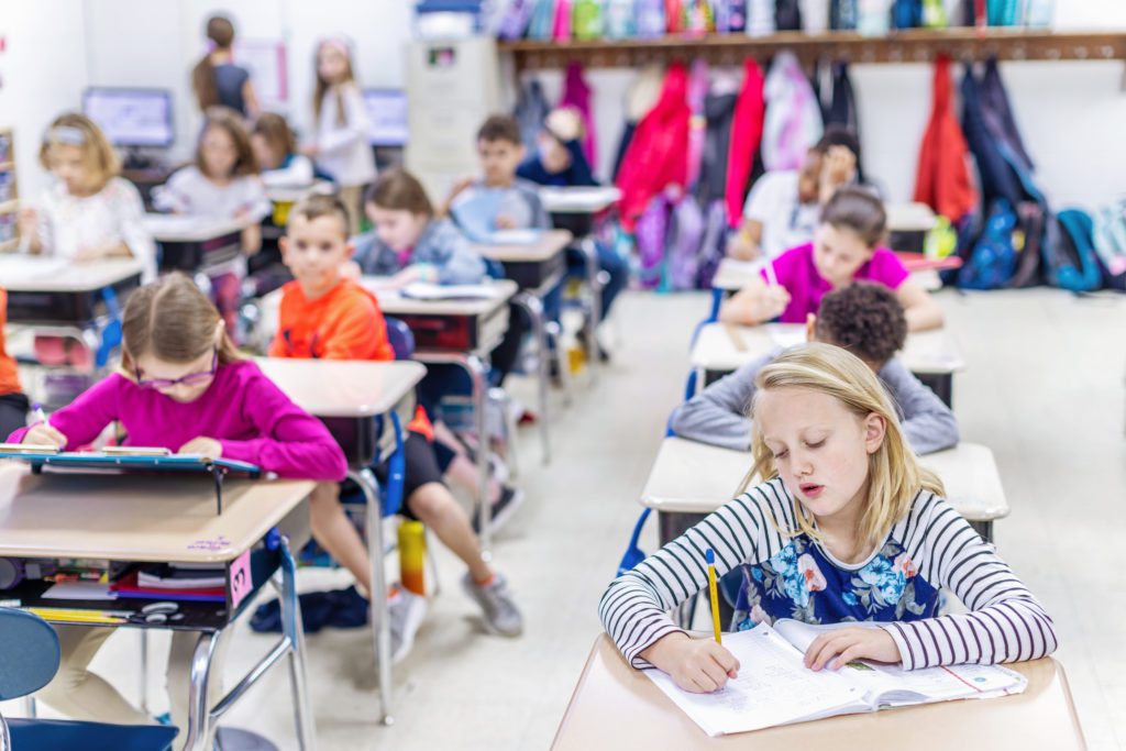 Photo of elementary students sitting at their desks.
