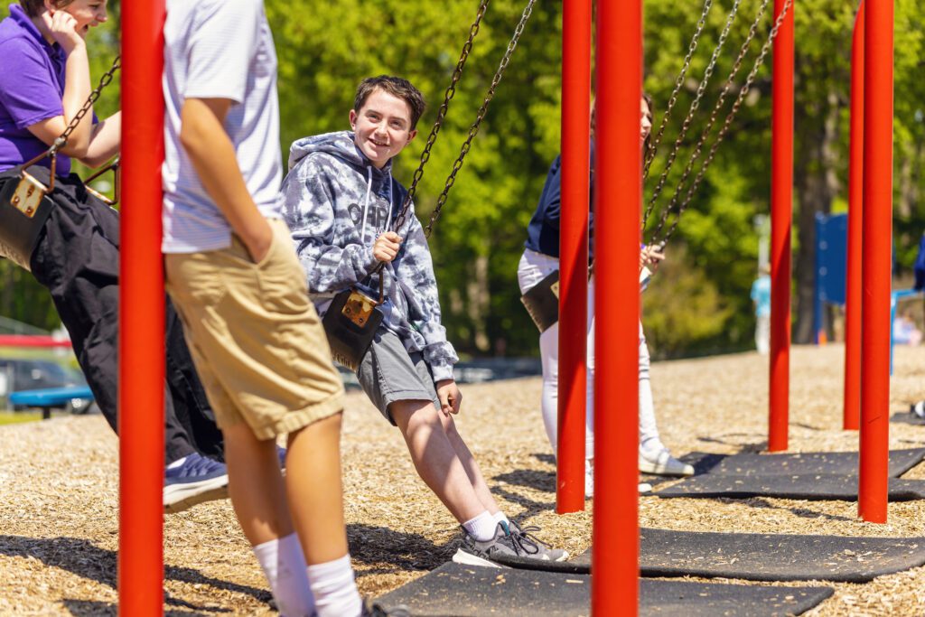 Wake Christian Academy middle school boy on swings